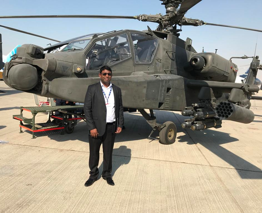 Shamendarn Pillay standing alongside an Attack Helicopter that he was the Program Director for.